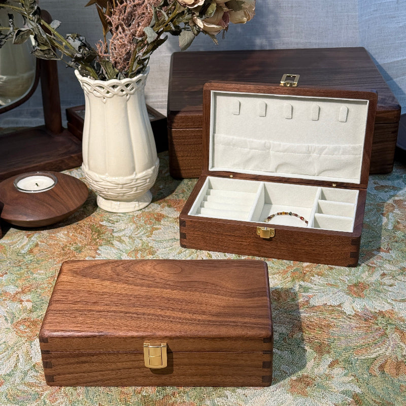 Wooden jewelry box with mirror on a floral-patterned wall