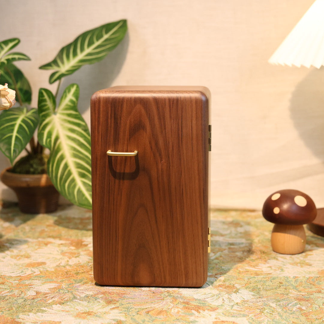 Wooden box on a decorative table with plants and a lamp in the background