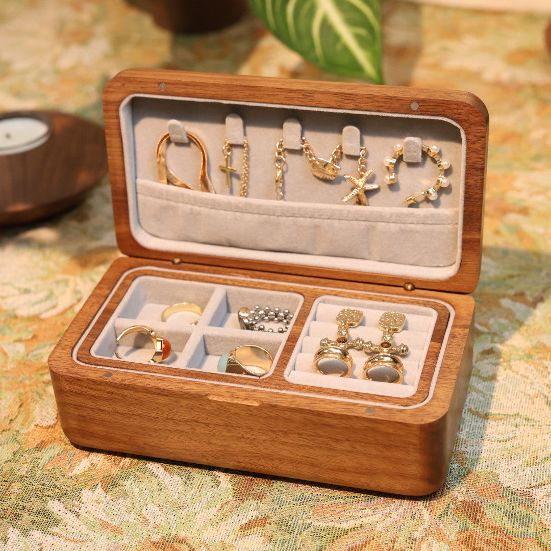 Wooden jewelry box with earrings on a patterned surface