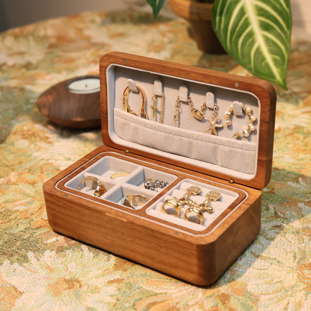 Wooden jewelry box with earrings on a floral tablecloth