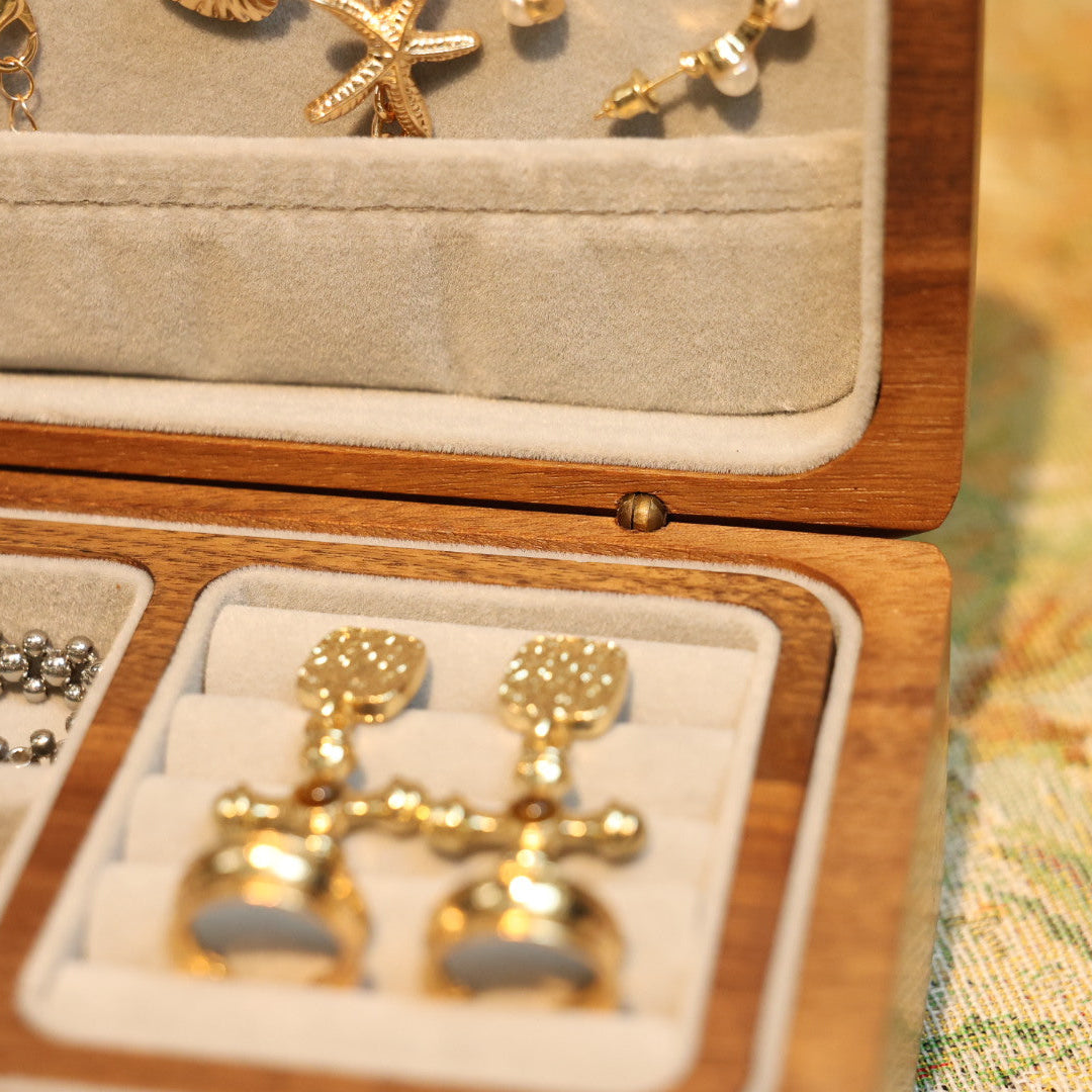 Gold earrings in a jewelry box with other items