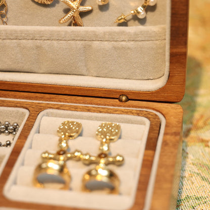 Gold earrings in a jewelry box with other items