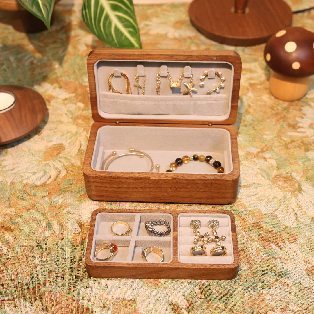 Wooden jewelry box with jewelry on a patterned surface