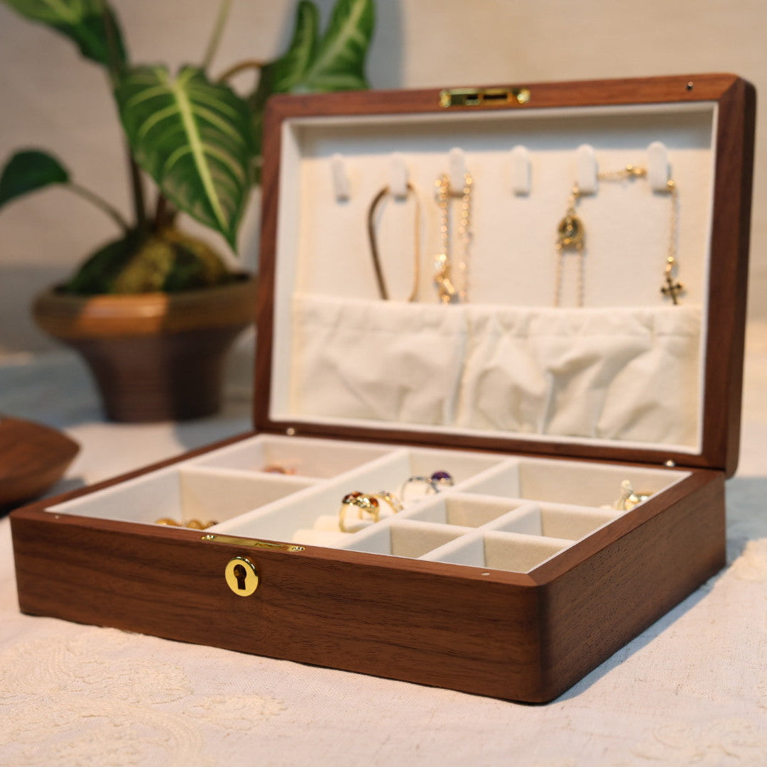 Wooden jewelry box with jewelry on a light surface