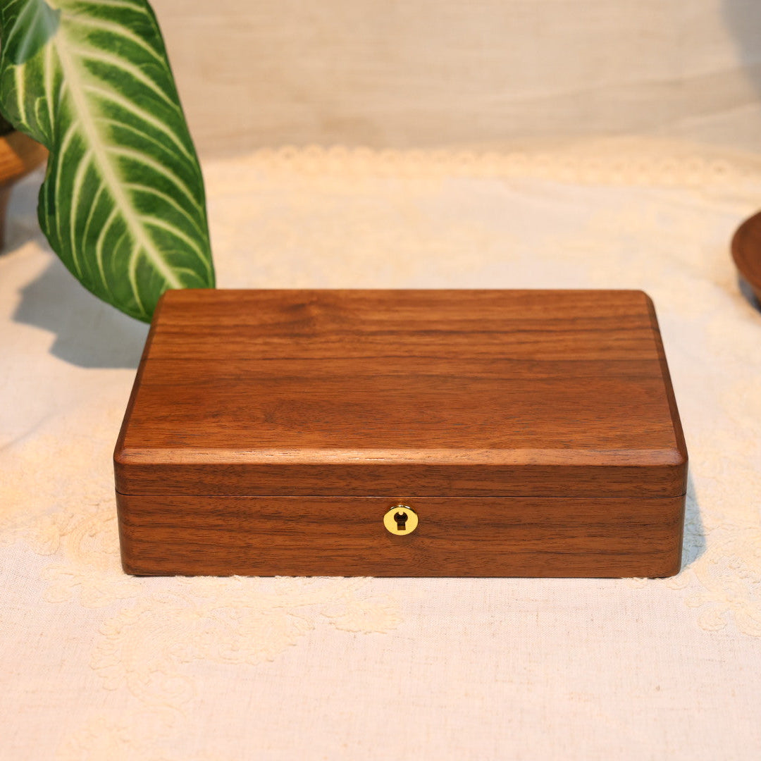 Wooden box with a keyhole on a textured surface with decorative elements.
