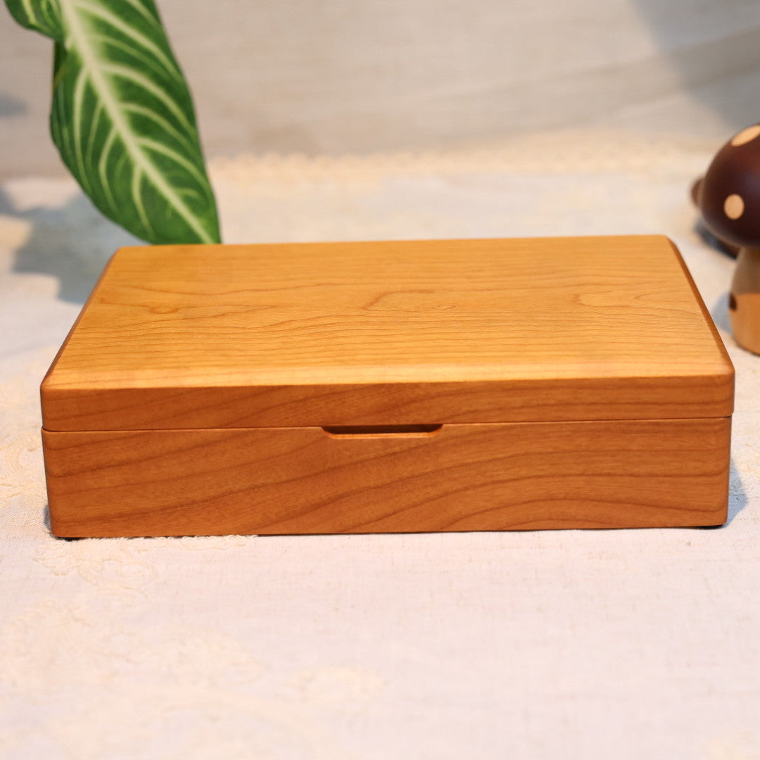 Wooden box on a light surface with decorative items around
