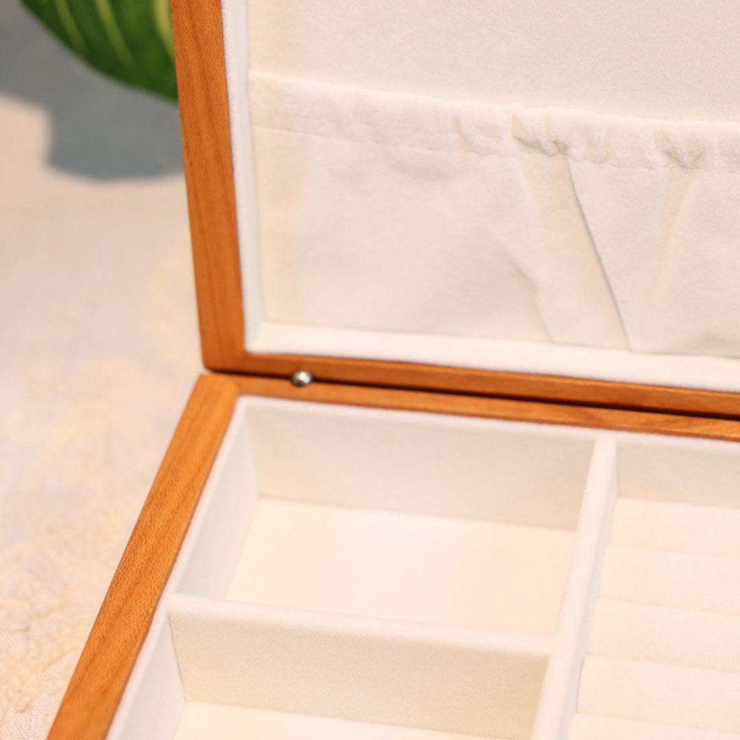 Wooden jewelry box with a mirror on a light surface