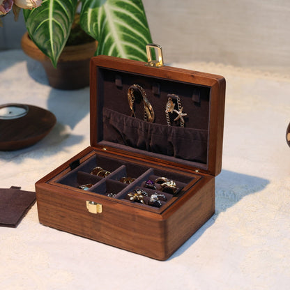 Wooden jewelry box with jewelry on a textured surface