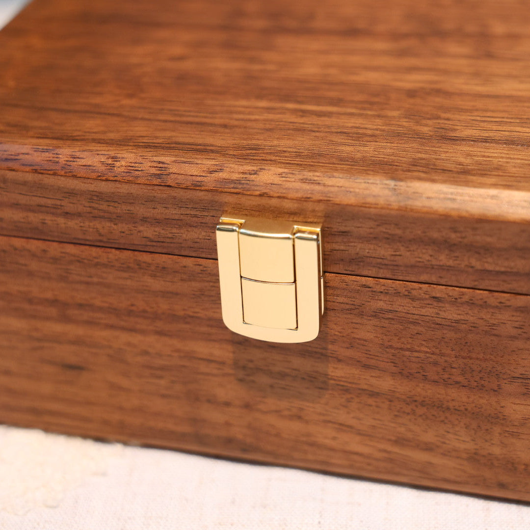 Wooden box with a gold latch on a light background