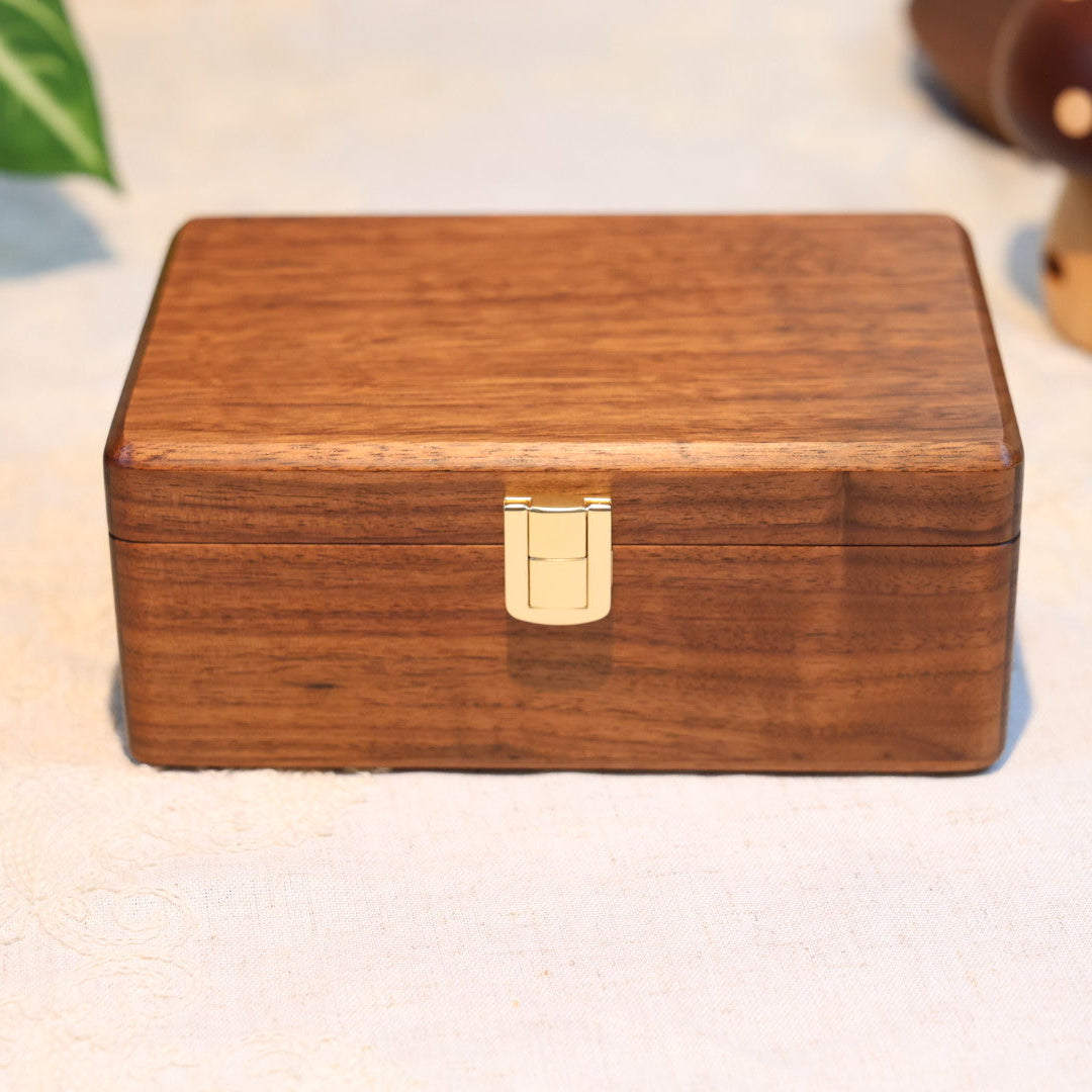 Wooden box with a metallic clasp on a light background