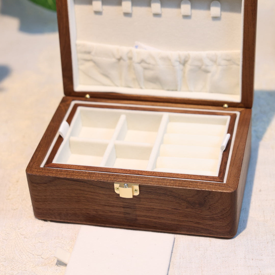 Wooden jewelry box with a mirror on a light surface