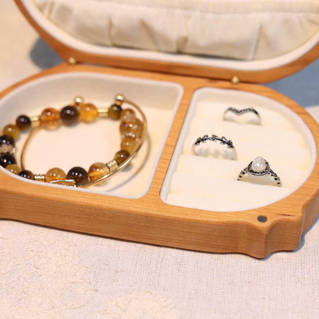 Jewelry set including a bracelet and two rings displayed in an open jewelry box.