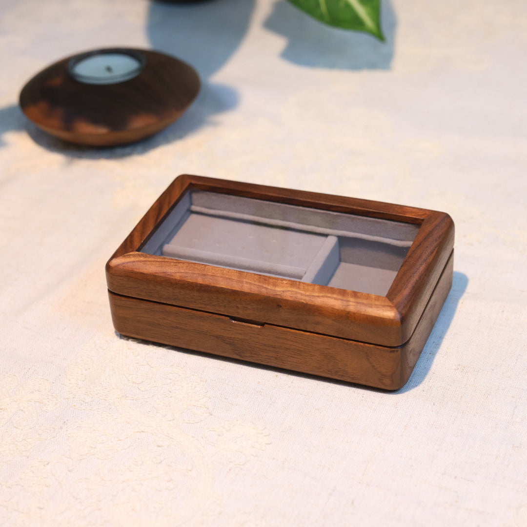 Wooden jewelry box on a light surface with blurred background