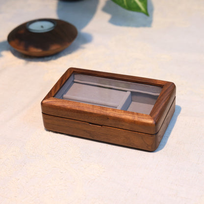 Wooden jewelry box on a light surface with blurred background
