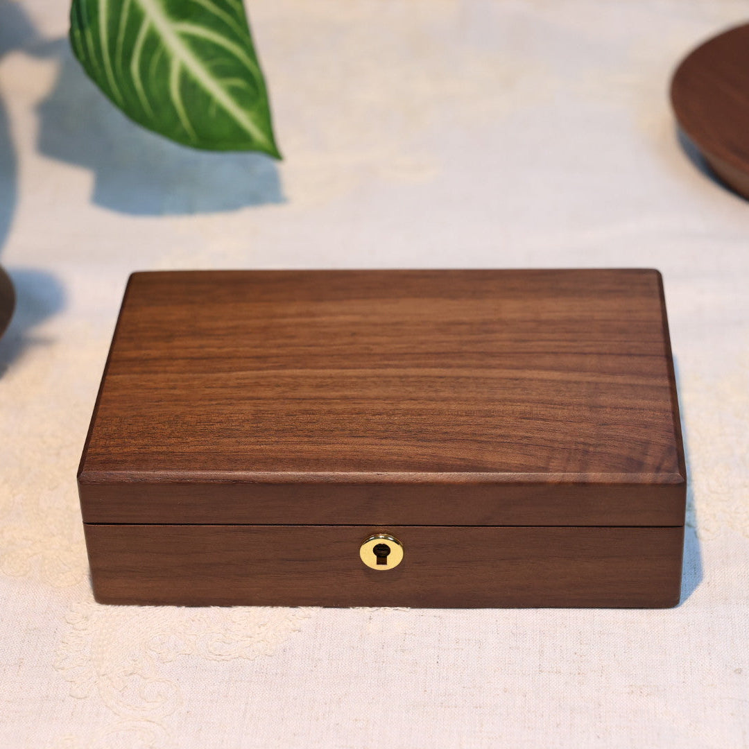 Wooden box with a decorative lock on a light fabric background