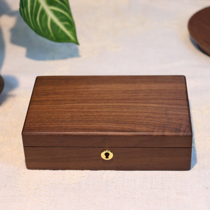 Wooden box with a decorative lock on a light fabric background
