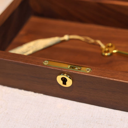 Wooden box with a gold lock and key on a textured surface