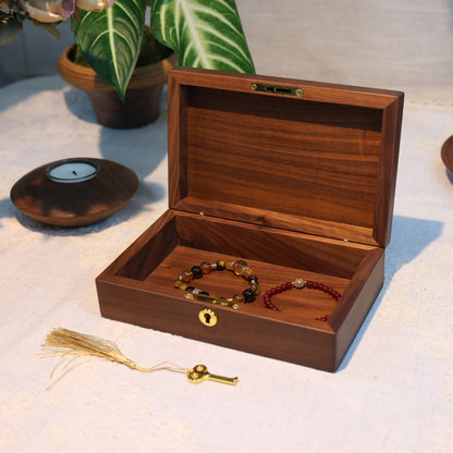 Wooden jewelry box with bracelets on a light surface