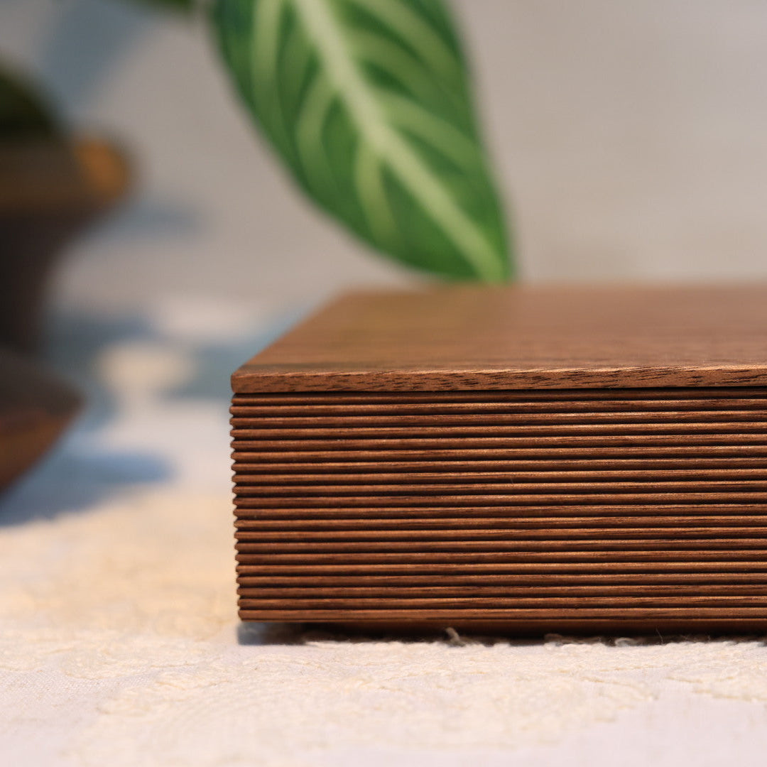 Close-up of a stack of brown paper or cardboard with a blurred background