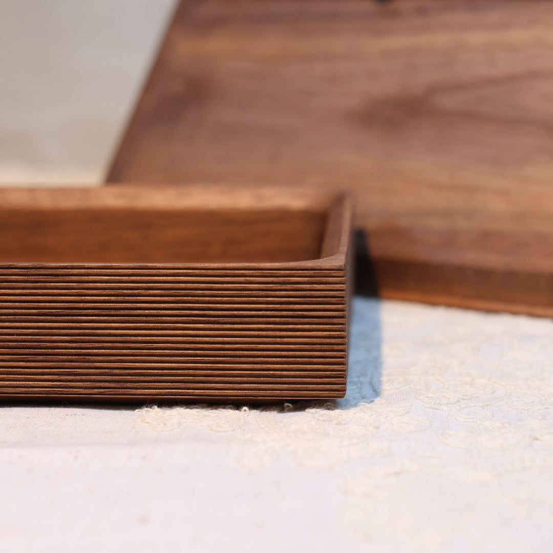 Close-up of a stack of brown cardboard boxes on a white surface.
