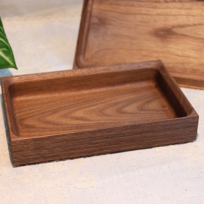 Wooden tray with lid on a light surface