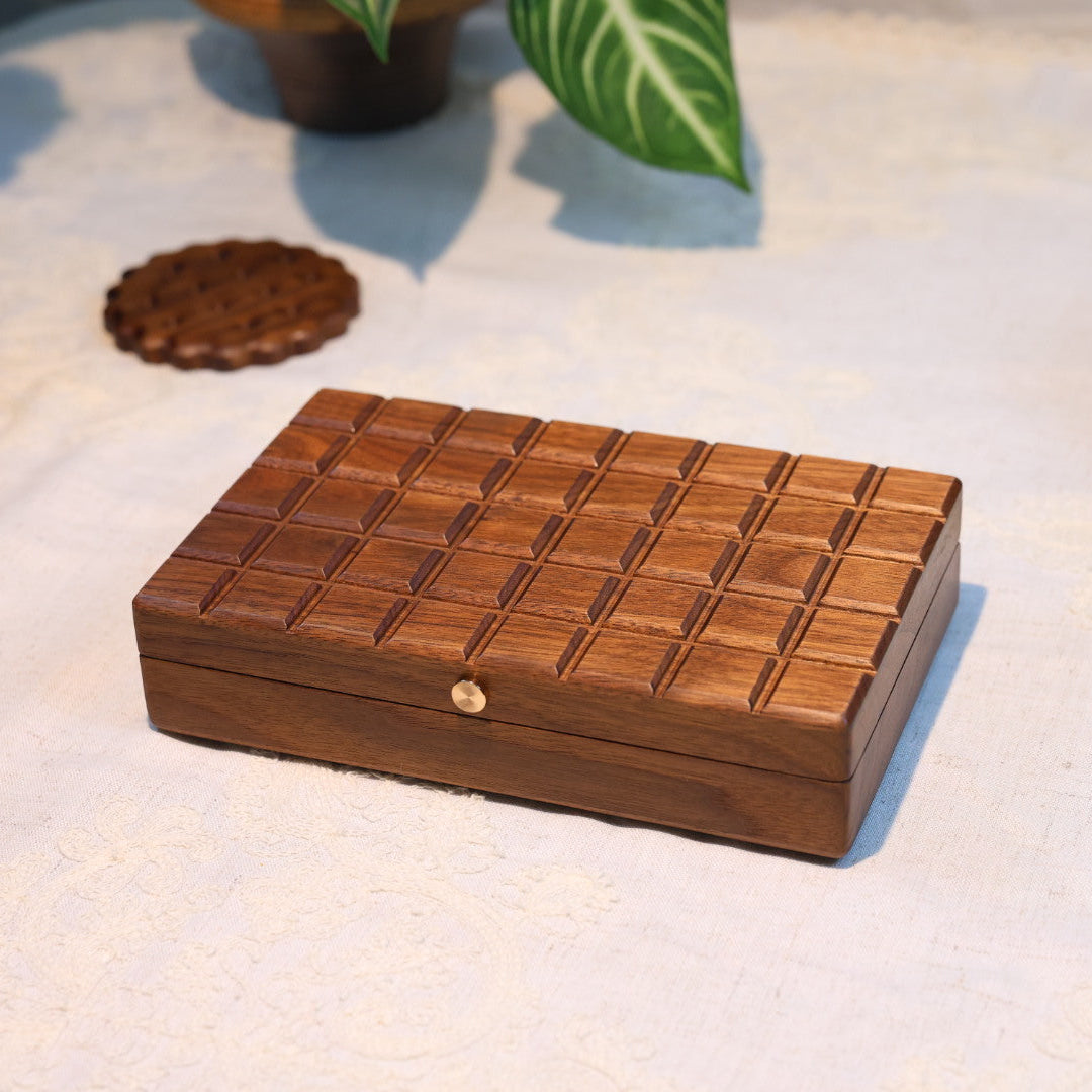 Wooden jewelry box with a checkered pattern on a light fabric background