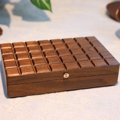 Wooden jewelry box with a textured surface on a light background