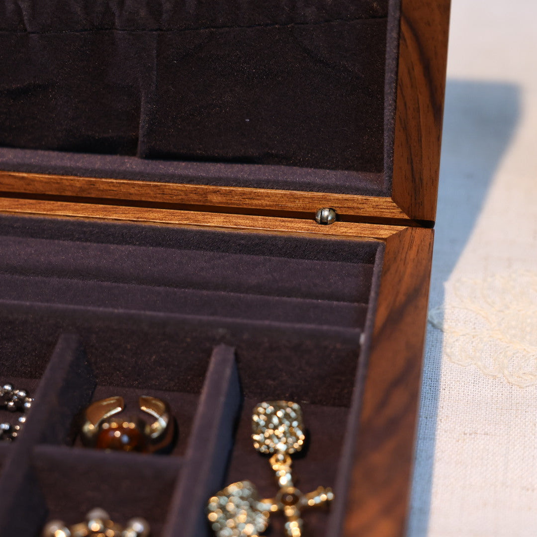 Open jewelry box with rings inside on a light background