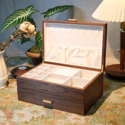 Wooden jewelry box on a table with decorative items in the background