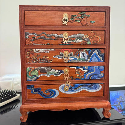 Wooden chest with decorative drawers on a black surface