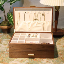 Wooden jewelry box with jewelry on a decorative table