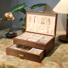 Wooden jewelry box with jewelry on a decorative table