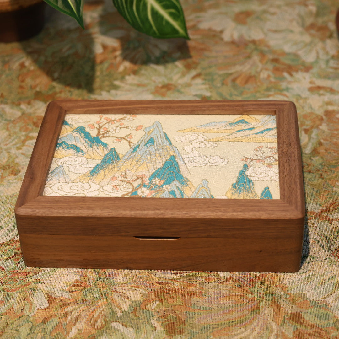 Wooden box with a scenic design on a patterned surface