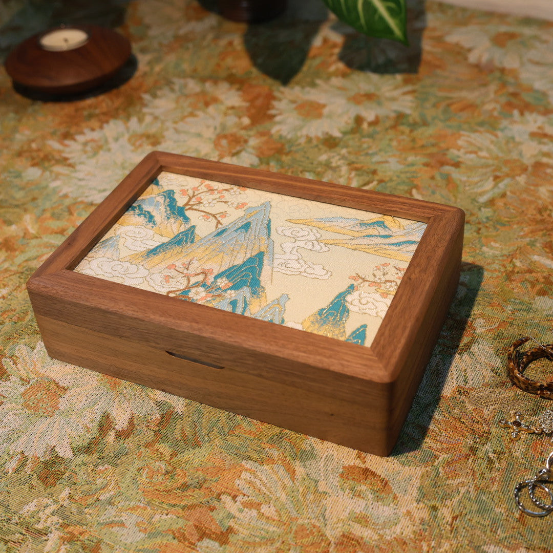 Wooden jewelry box with decorative lid on a patterned surface