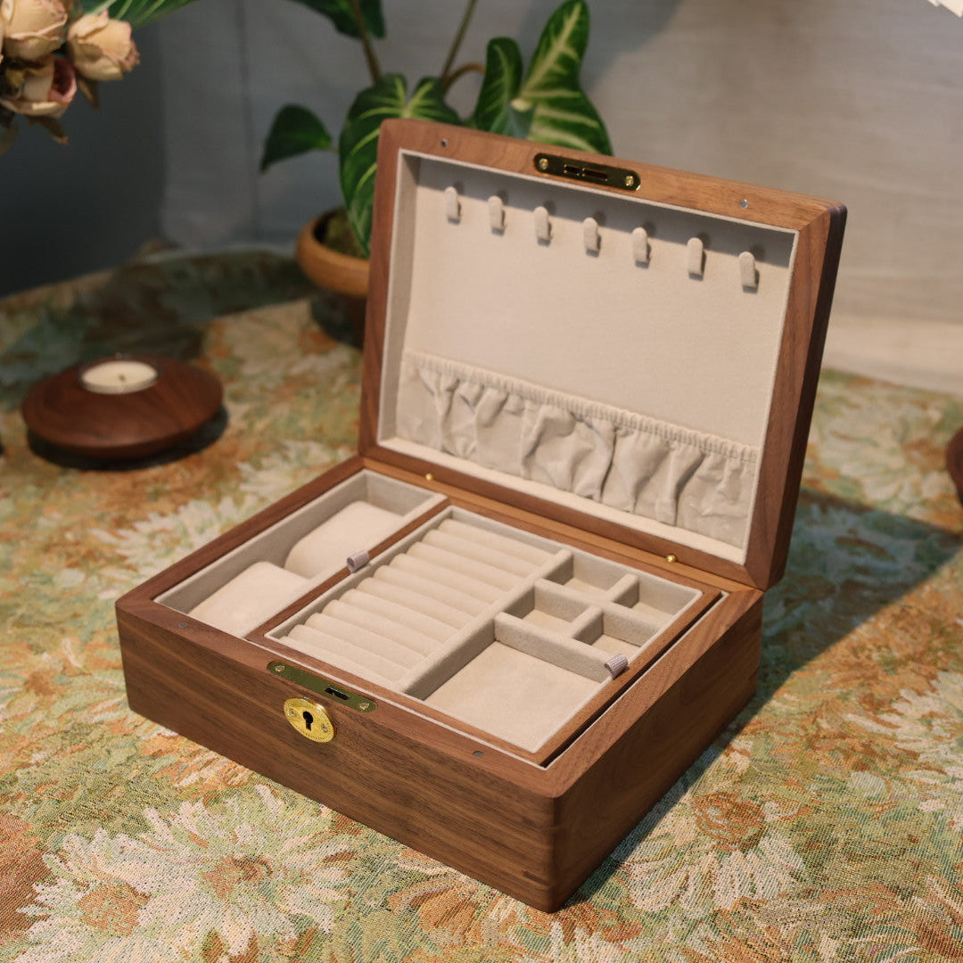 Wooden jewelry box with jewelry on a floral tablecloth