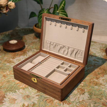 Wooden jewelry box with jewelry on a floral tablecloth