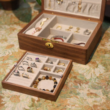 Wooden jewelry box with rings on a patterned surface