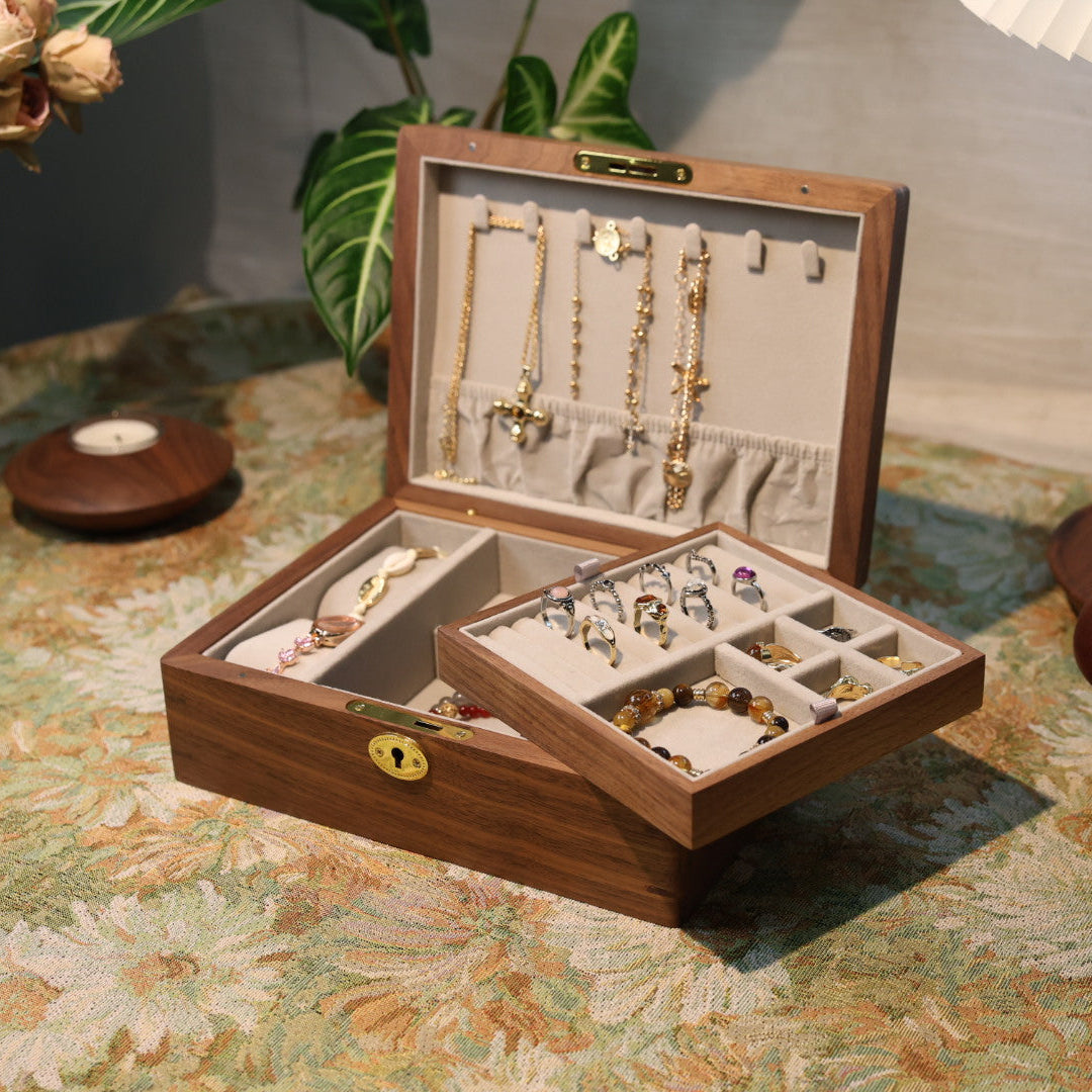 Wooden jewelry box with jewelry on a patterned tablecloth
