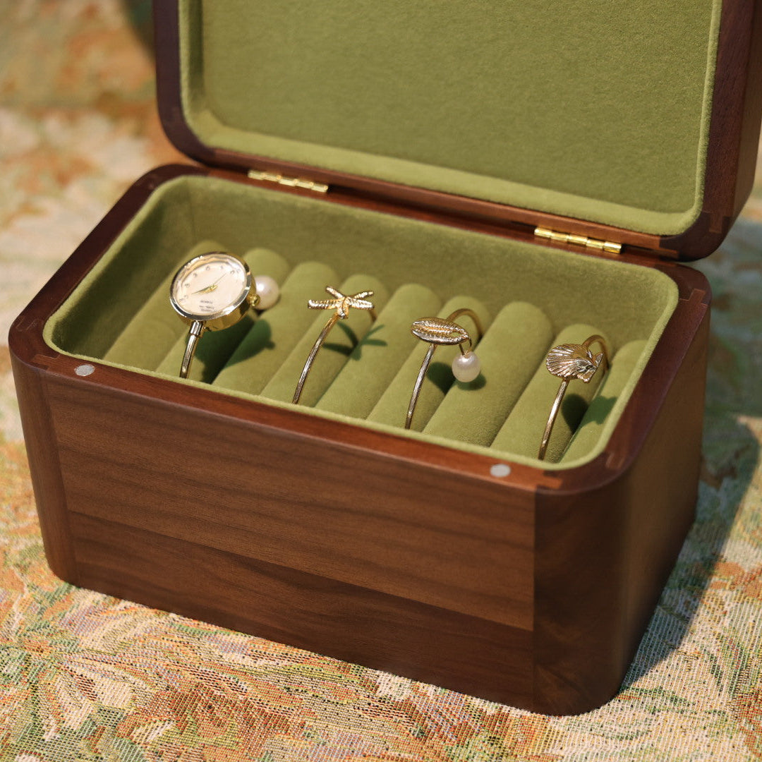 Open jewelry box with rings on a patterned surface