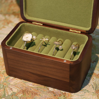 Open jewelry box with rings on a patterned surface