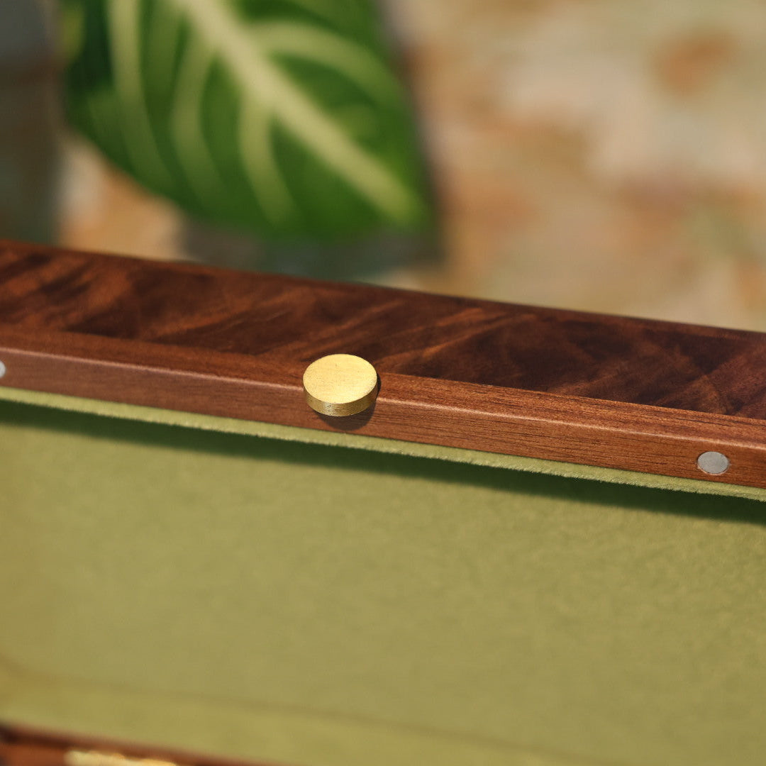 Wooden jewelry box with a gold clasp on a natural background