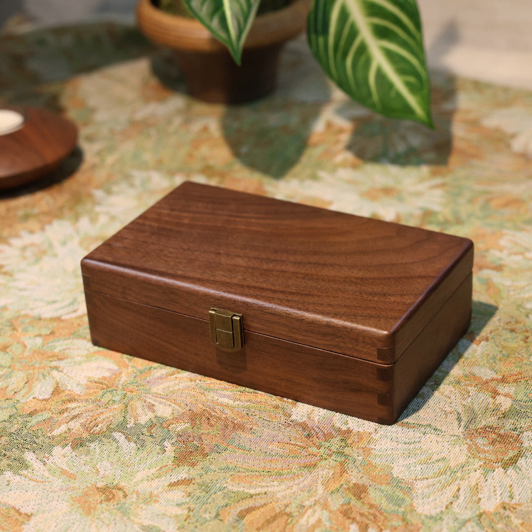 Wooden jewelry box on a floral-patterned surface