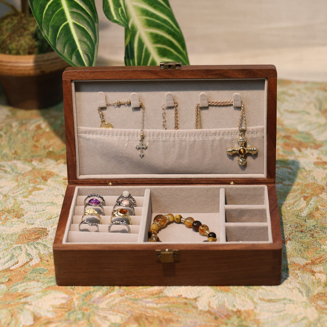Wooden jewelry box with jewelry on a patterned surface