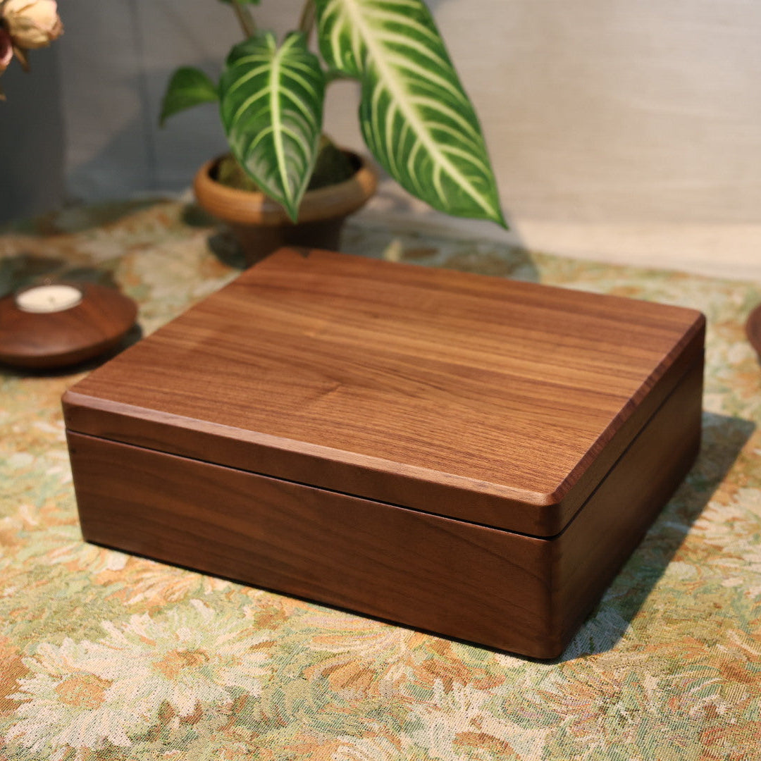 Wooden box on a patterned surface with decorative items in the background