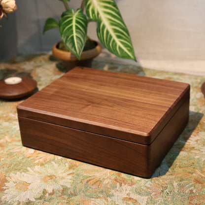 Wooden box on a patterned surface with decorative items in the background