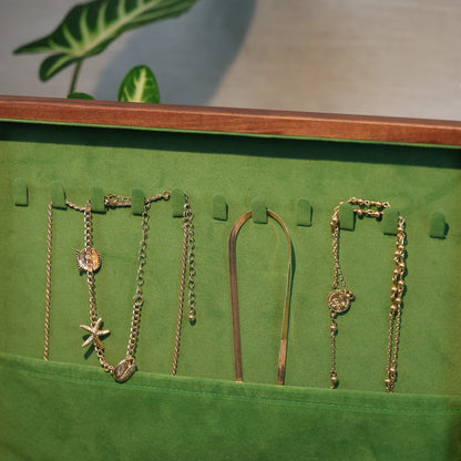 Green jewelry display with necklaces on a wooden frame