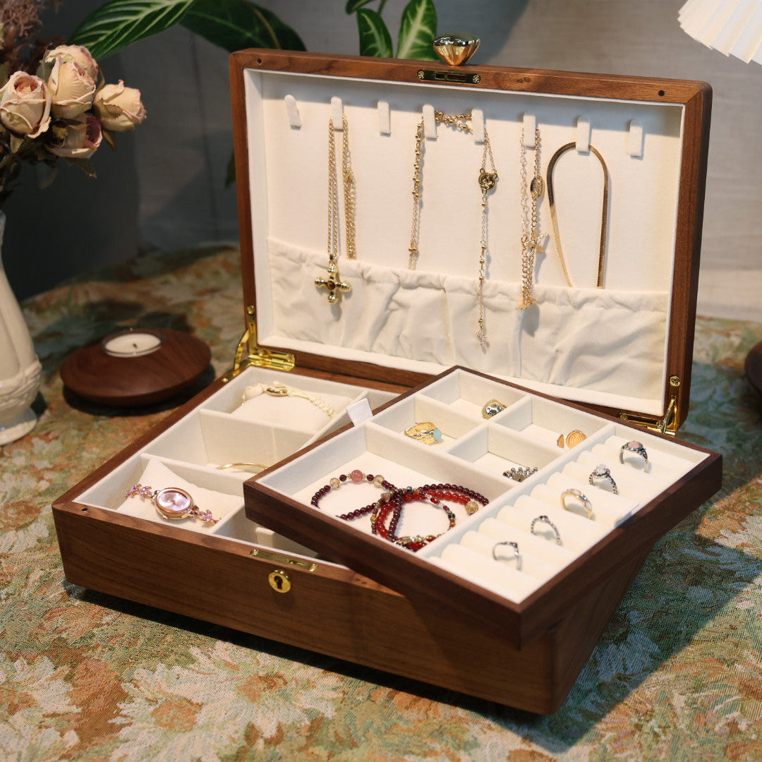 Jewelry box with various jewelry items on a patterned surface