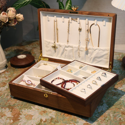 Jewelry box with various jewelry items on a patterned surface