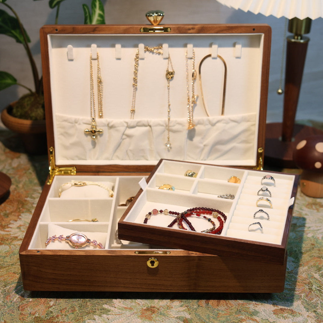 Open jewelry box with necklaces and earrings on a patterned surface