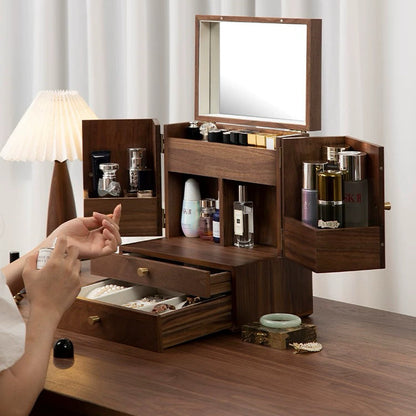 Wooden jewelry box with various items on a wooden surface.